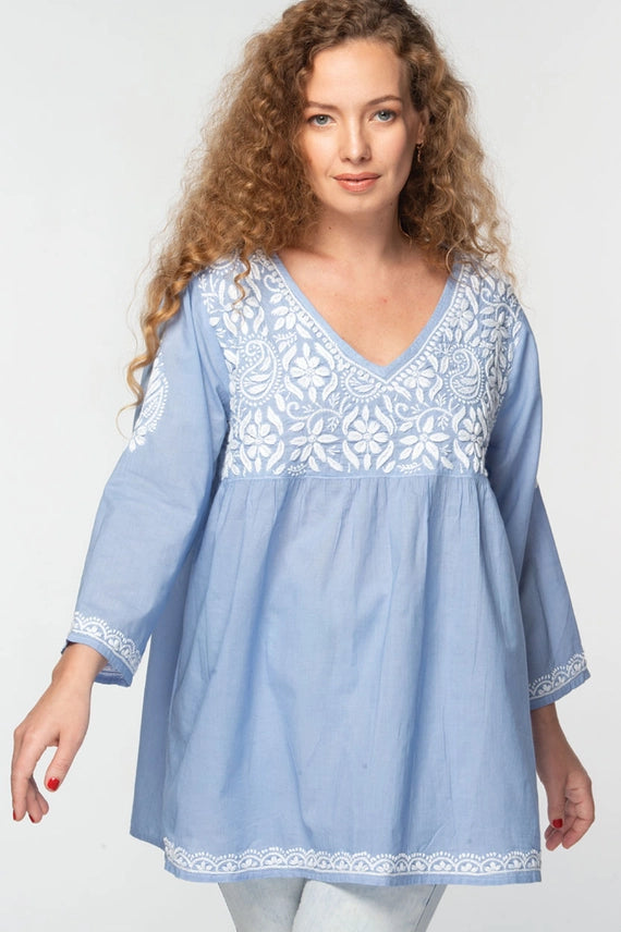 A light blue baby doll tunic with white hand embroidered details