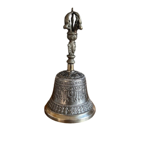 A bronze-colored ritual bell with a handle on top, featuring intricate designs on its surface.