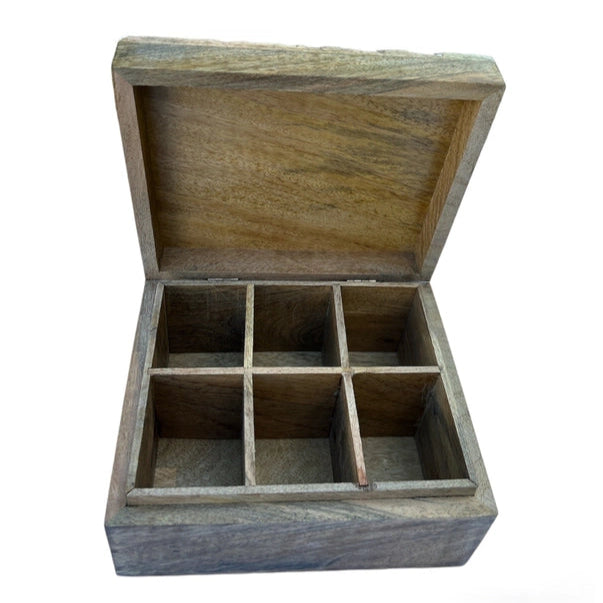 Wooden jewelry box with compartments on a white background