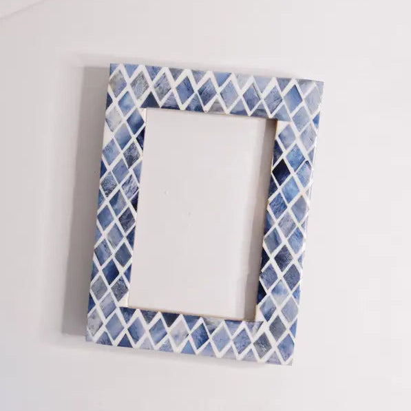 Decorative picture frame with blue and white pattern on a white background