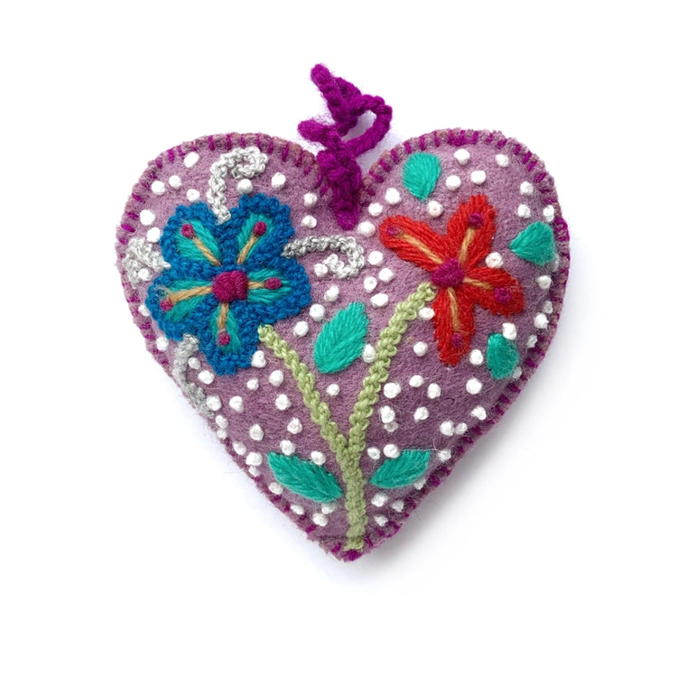 Decorative purple heart-shaped ornament with embroidered flowers on a white background
