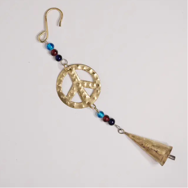 Decorative peace symbol ornament with beads and a cone on a white background