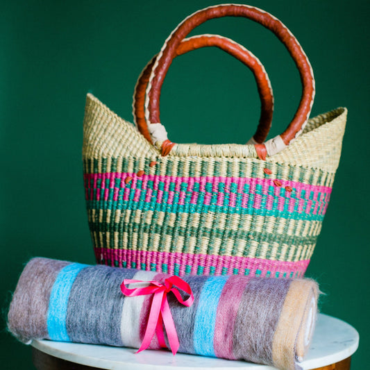 african shopping basket with alpaca striped blanket rolled pink ribbin