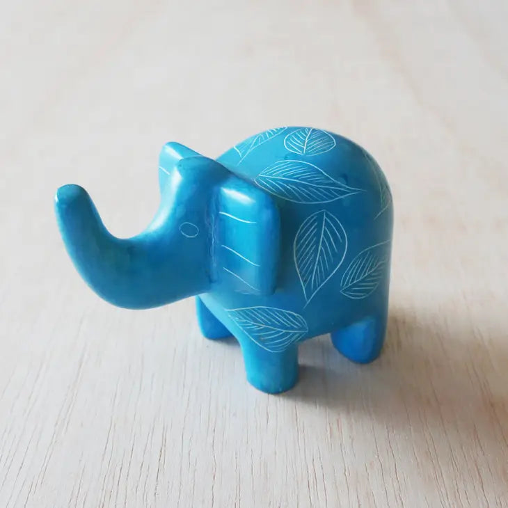 A small pale blue elephant-shaped soapstone with etched patterns that can be used as a ring holder.