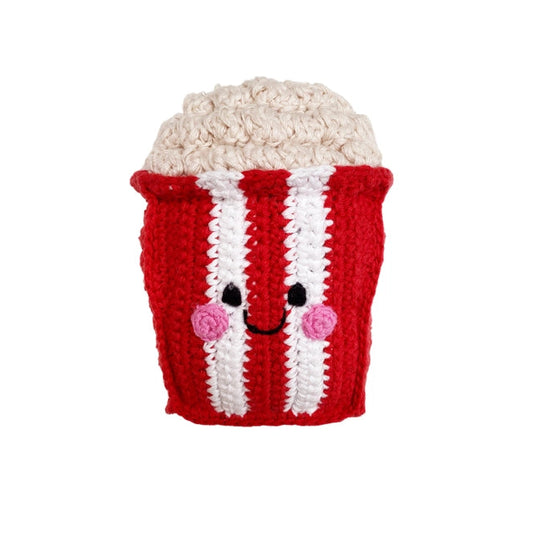 Crocheted popcorn container with a face on a white background