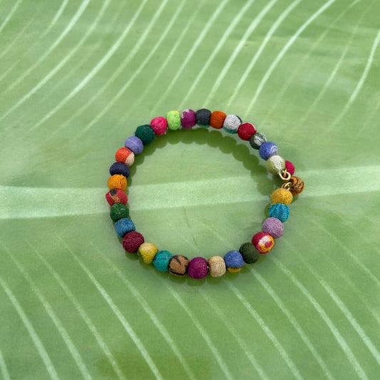 Colorful beaded bracelet on a green leaf