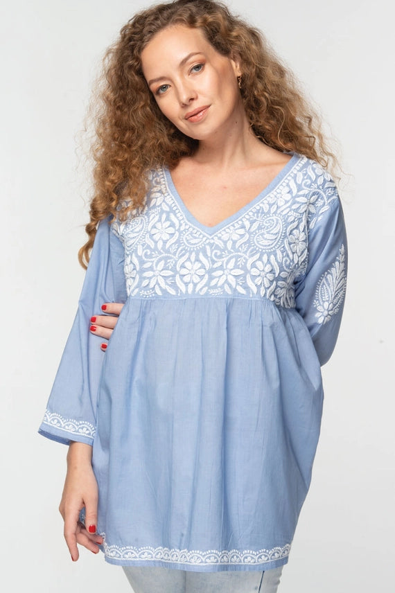 A light blue baby doll tunic with white hand embroidered details 