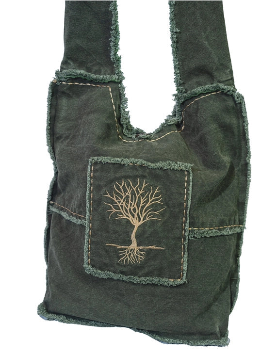 A dark green frayed-edge canvas shoulder bag with a front pocket featuring a beige embroidered tree of life design, shown against a plain white background.