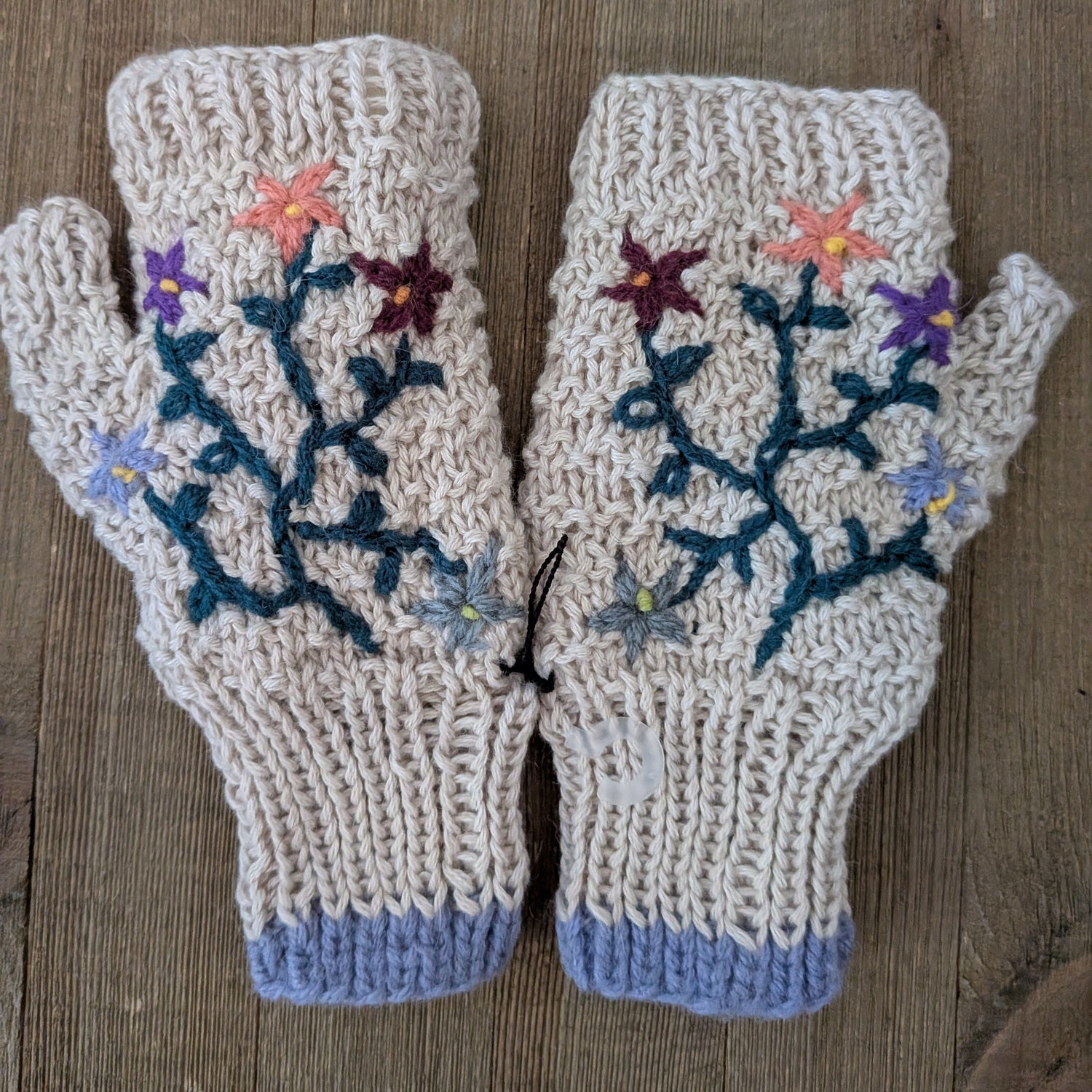 Pair of knitted fingerless gloves with floral patterns 