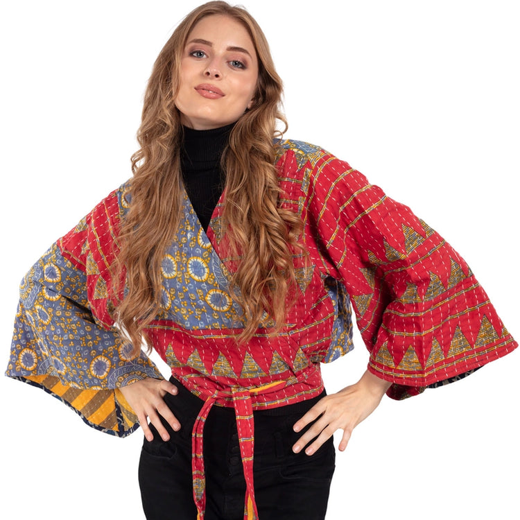 Woman wearing a colorful patterned  top with bell sleeves. Made from Upcycled Kantha fabric.