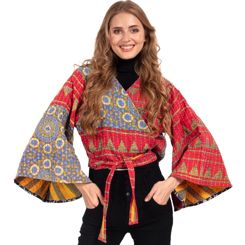 Woman wearing a colorful patterned  top with bell sleeves. Made from Upcycled Kantha fabric.