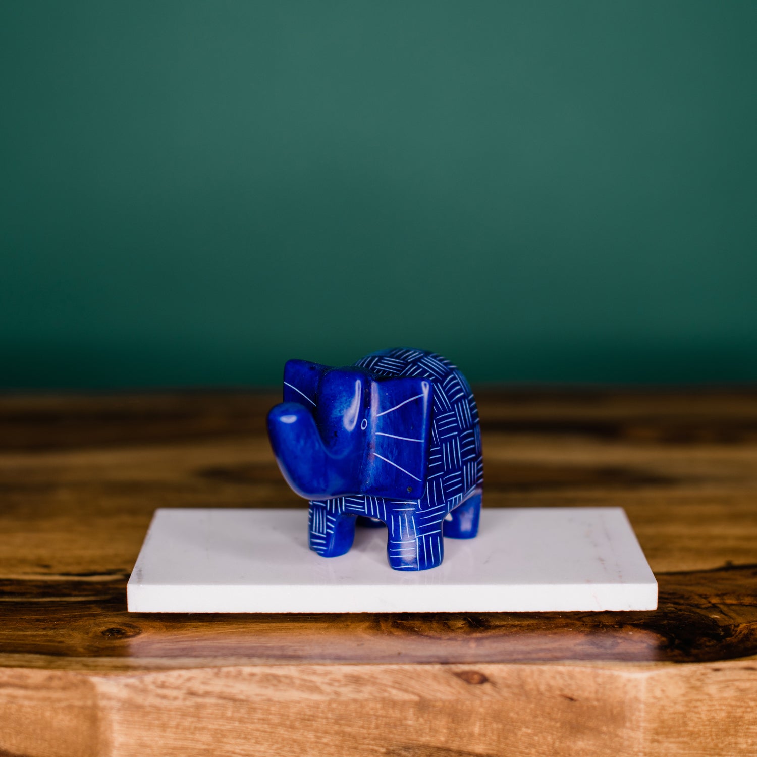 A small blue elephant-shaped soapstone with etched patterns that can be used as a ring holder.