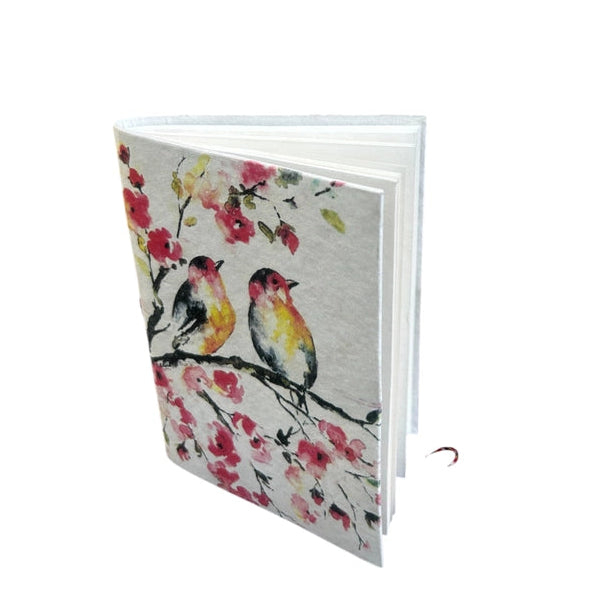Notebook with bird and floral design on a white background