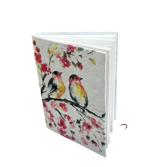 Notebook with bird and floral design on a white background