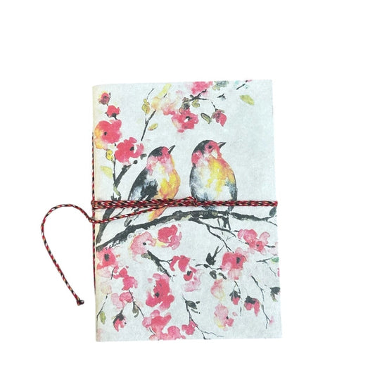 Notebook with bird and floral design on a white background