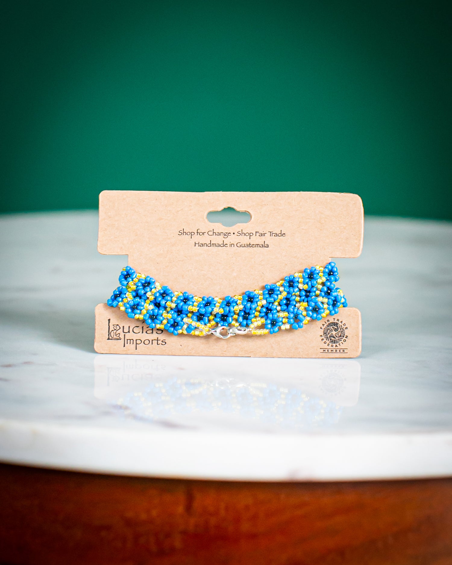 teal beaded mask chain on display card