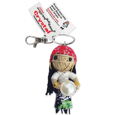 A handmade string doll keychain named 'Crystal' with a crystal ball, dressed in a red and white outfit.
