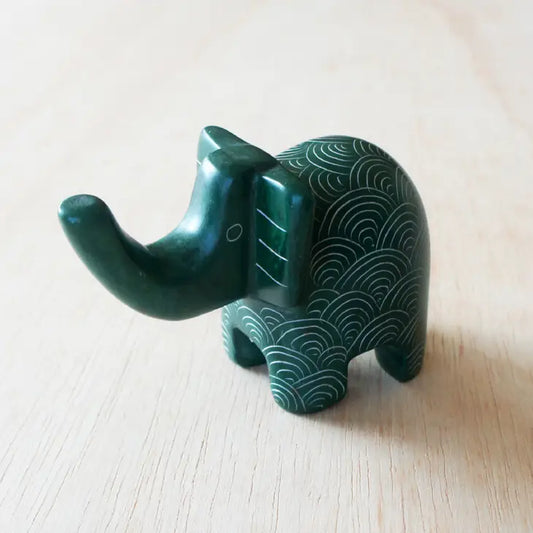 A small green elephant-shaped soapstone with etched patterns that can be used as a ring holder.