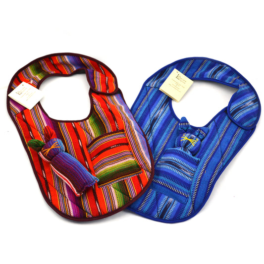 A colorful handmade baby bib with a pocket featuring a removable bunny inside, made from vibrant Guatemalan fabric.