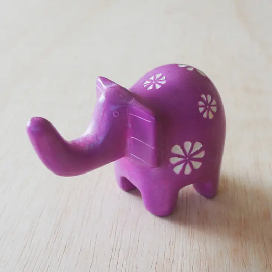 A small pink elephant-shaped soapstone with etched patterns that can be used as a ring holder.