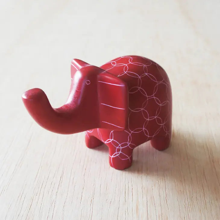 A small red elephant-shaped soapstone with etched patterns that can be used as a ring holder.